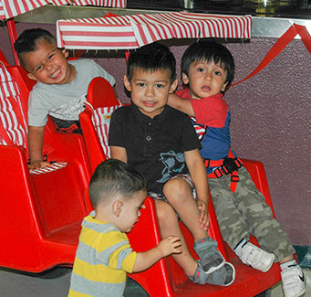 Preschool students riding on a kid's train ride