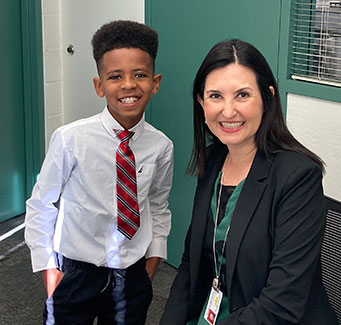 Superintendent with a student helping being the superintendent for a day
